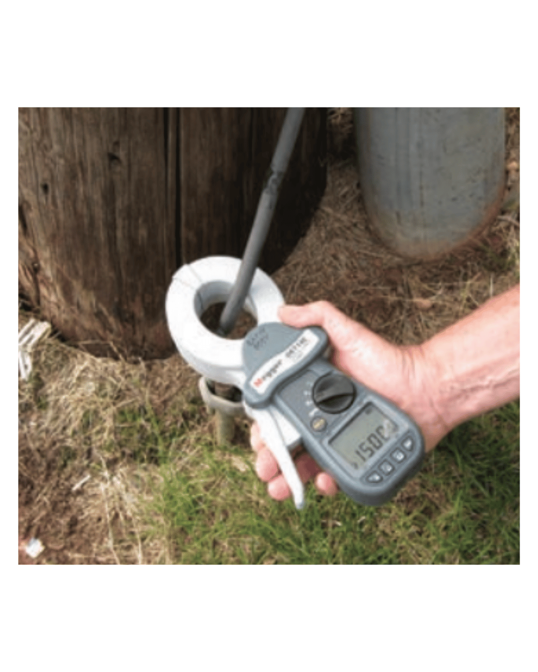 Megger DET24C clamp-on ground tester in use to test a pole ground