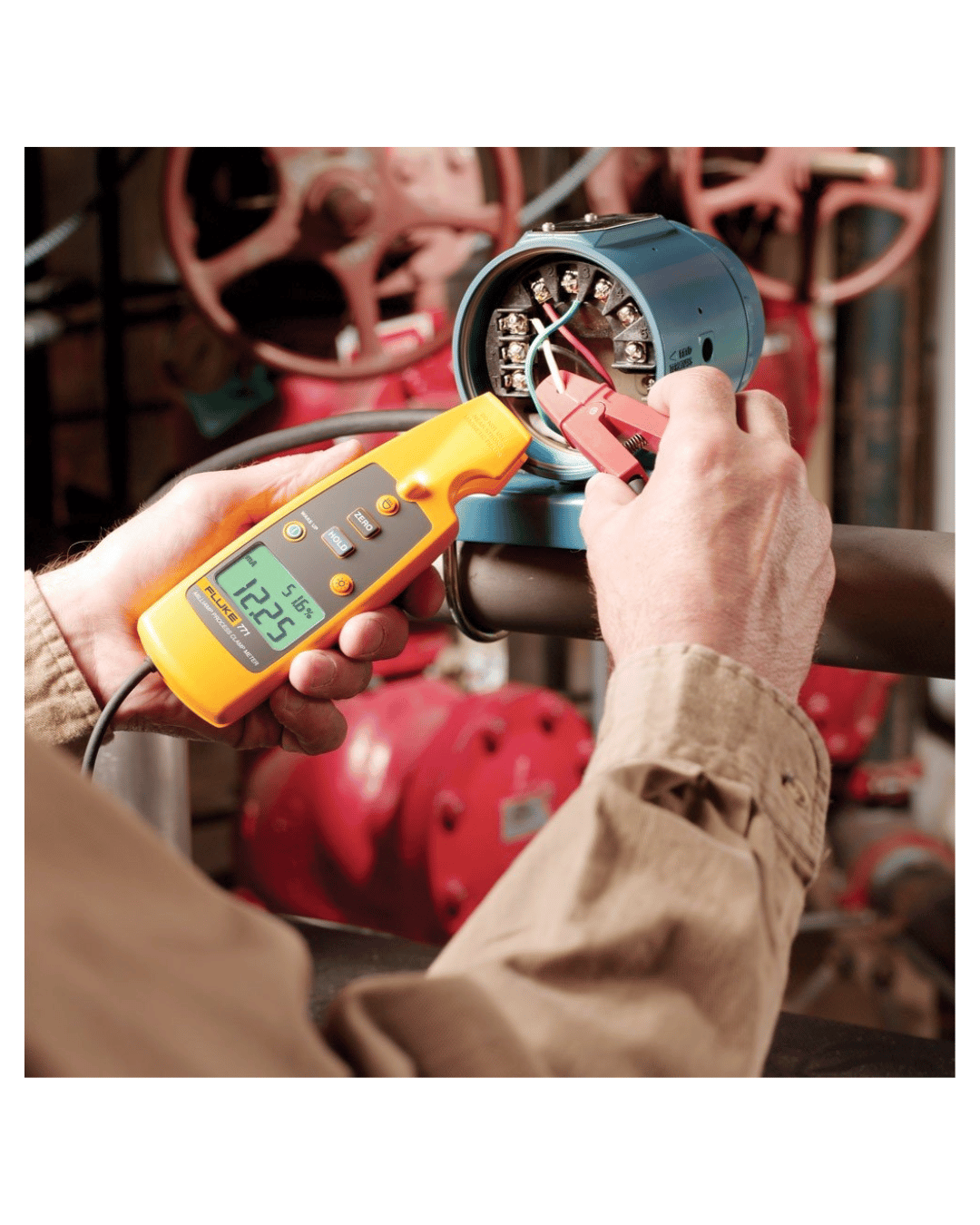 Handheld Fluke 771 process clamp meter testig electrical wiring in an industrial environmet