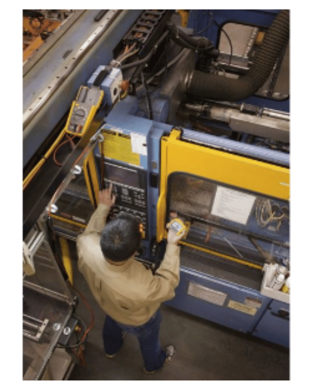 Technician using Fluke 233 digital multimeter for industrial equipment