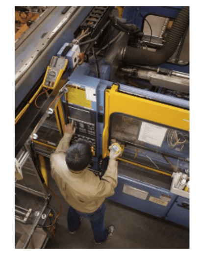 Technician using Fluke 233 digital multimeter for industrial equipment